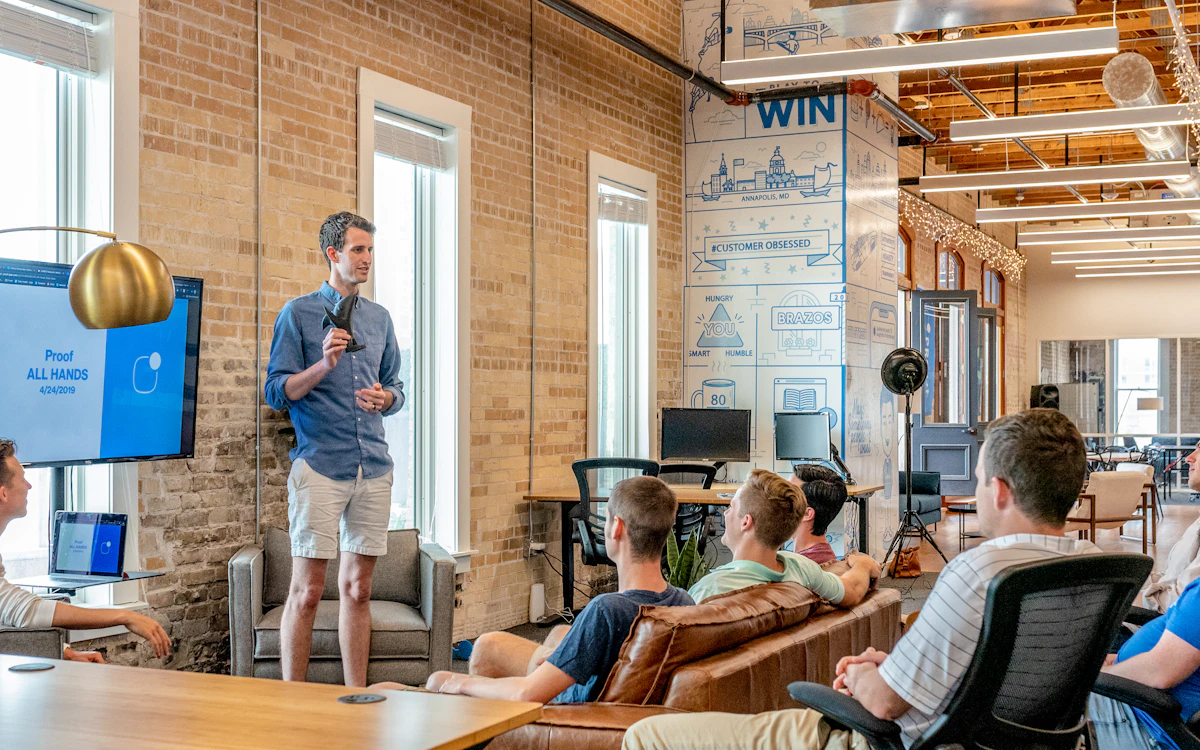 Two founders reviewing feedback and notes around a workspace laptop